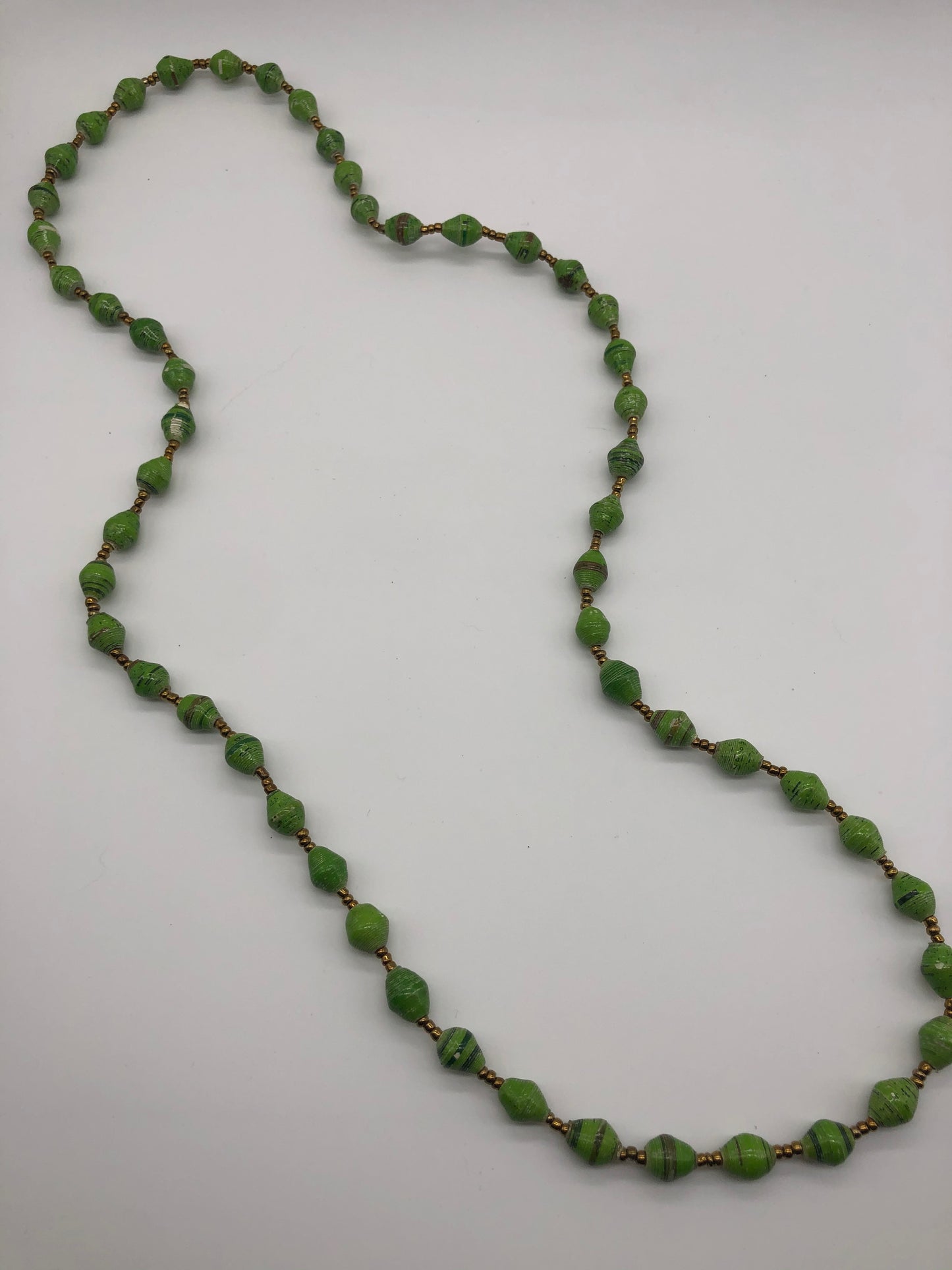 Hand made colorful medium length multicolor necklace made from magazines with accent seed beads in between. Each bead is hand rolled. Stylish and fashionable for casual or dressy. Fair trade.  Approximately 18" L