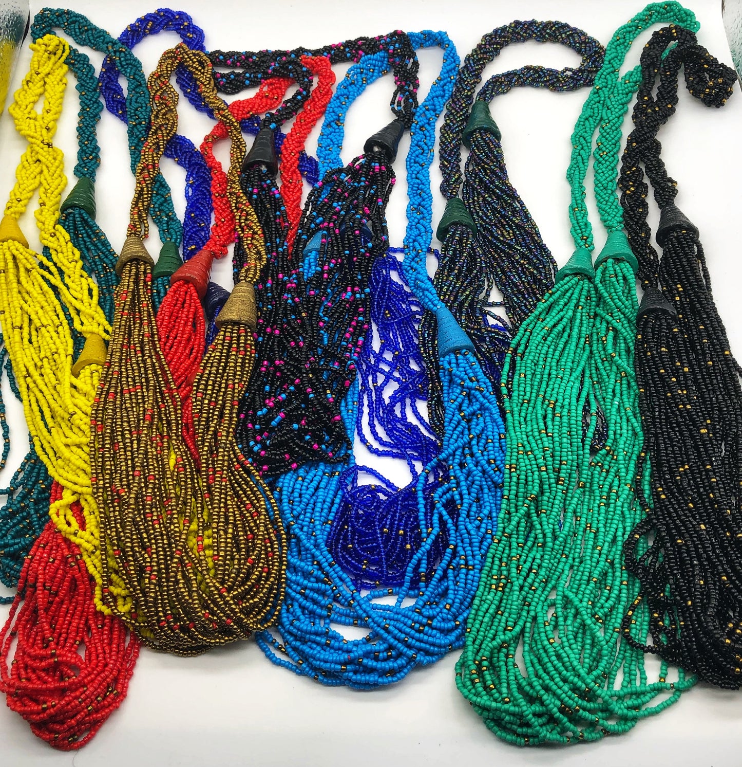 Make a statement with this beautiful handmade seed bead necklace. Styled with braided beads around the neck flowing into a loose styled design. Multiple colors pictured