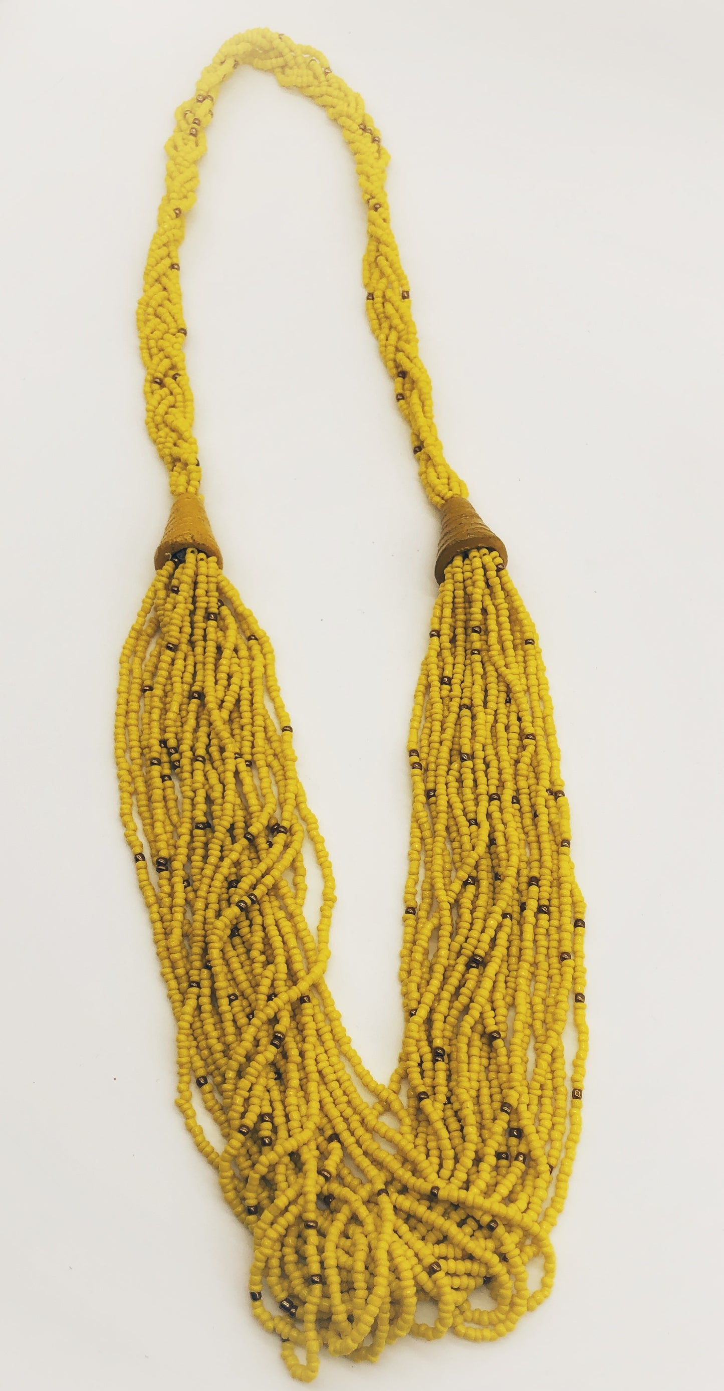 Make a statement with this beautiful handmade seed bead necklace. Styled with braided beads around the neck flowing into a loose styled design. Yellow with gold bead accent