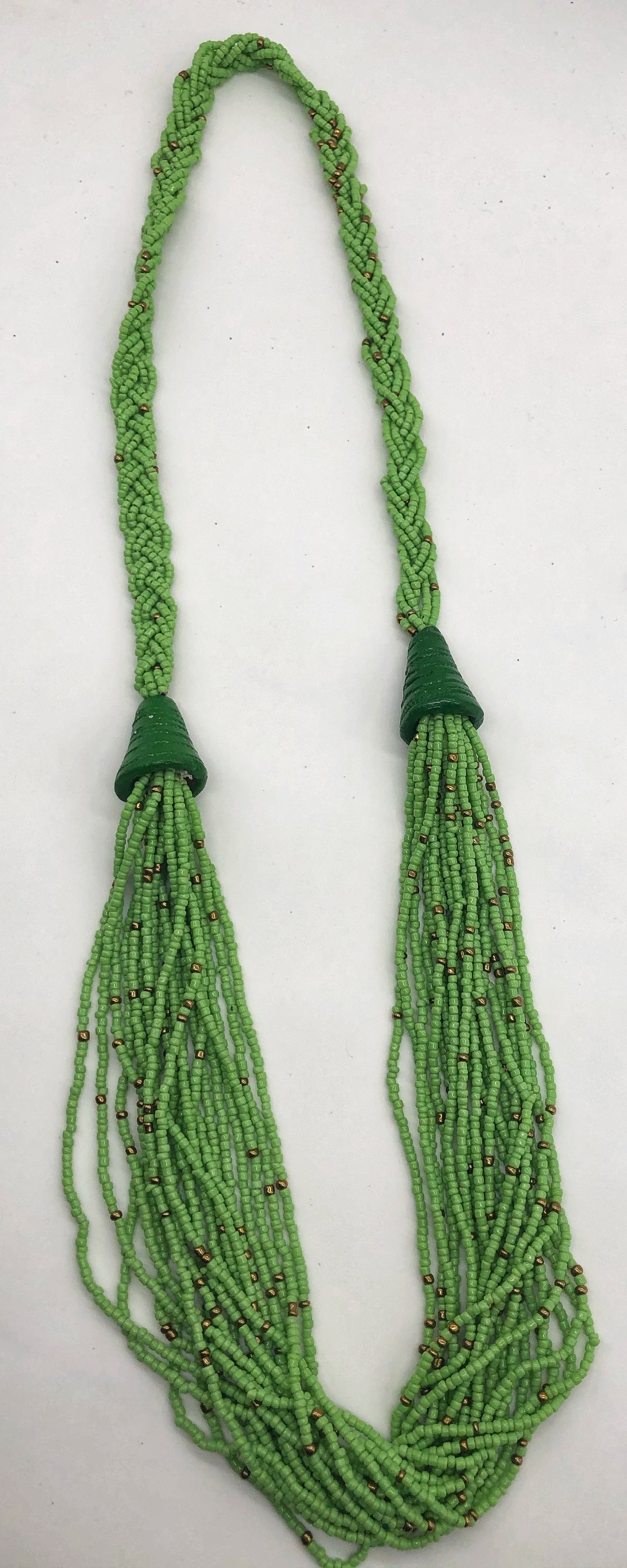 Make a statement with this beautiful handmade seed bead necklace. Styled with braided beads around the neck flowing into a loose styled design. Pear green