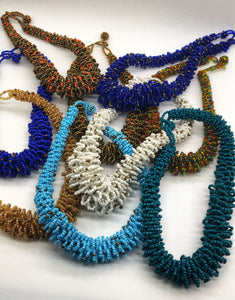 Stand out in style with this beautiful handmade loop bead style necklace.  Hover over the photo to see the detail of how the beads are made into a loop design.  Thoughtfully designed for style and stand out fashion. Approximately 18" end to end.  Multiple colors shown.