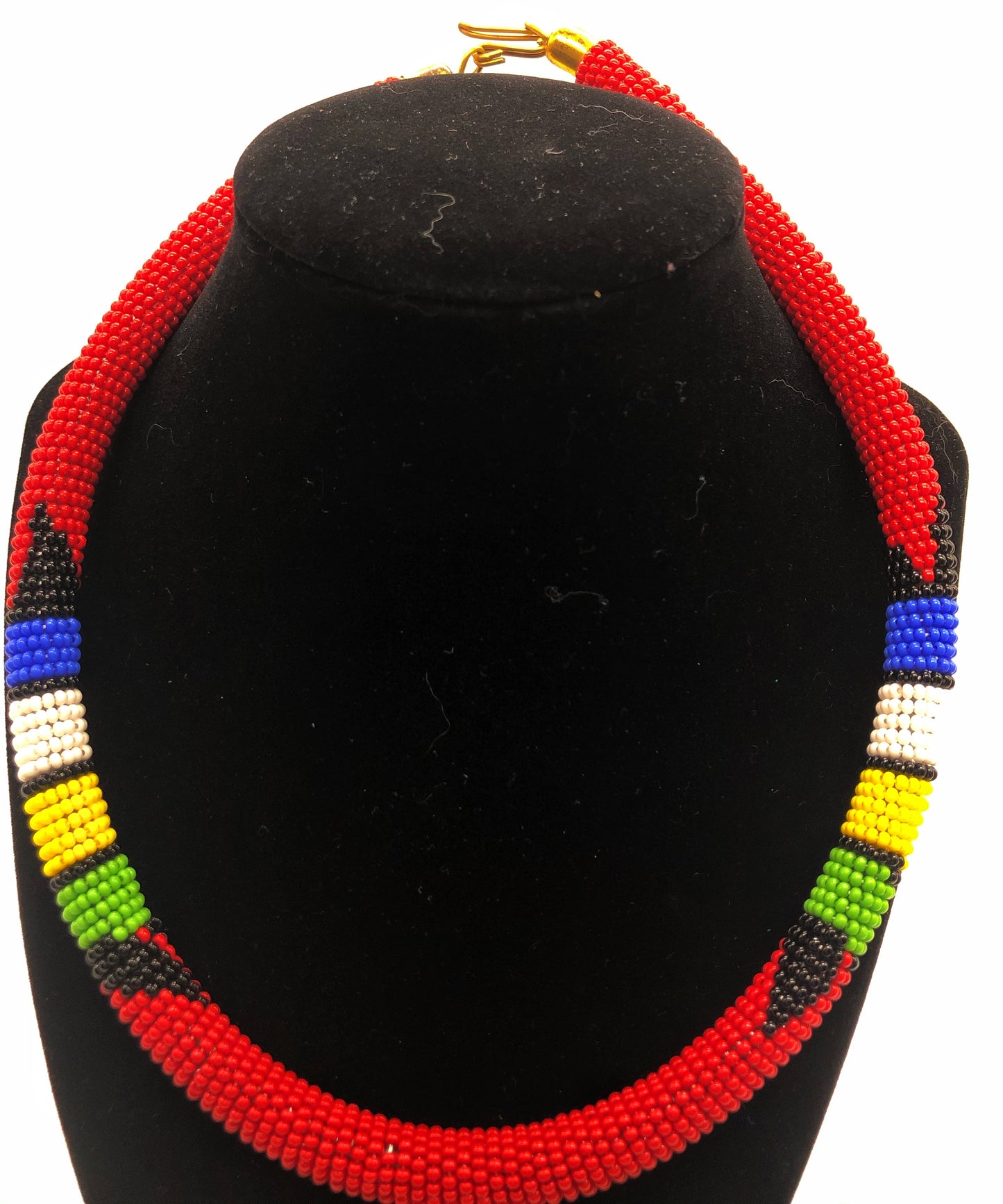Wear the epitome of Kenya style with The Bintiah necklace. This necklace is handmade using colorful seed beads that are intricately and tightly wrapped around a solid piece fo make a stunning statement with any outfit. Red pictured with colorful accent