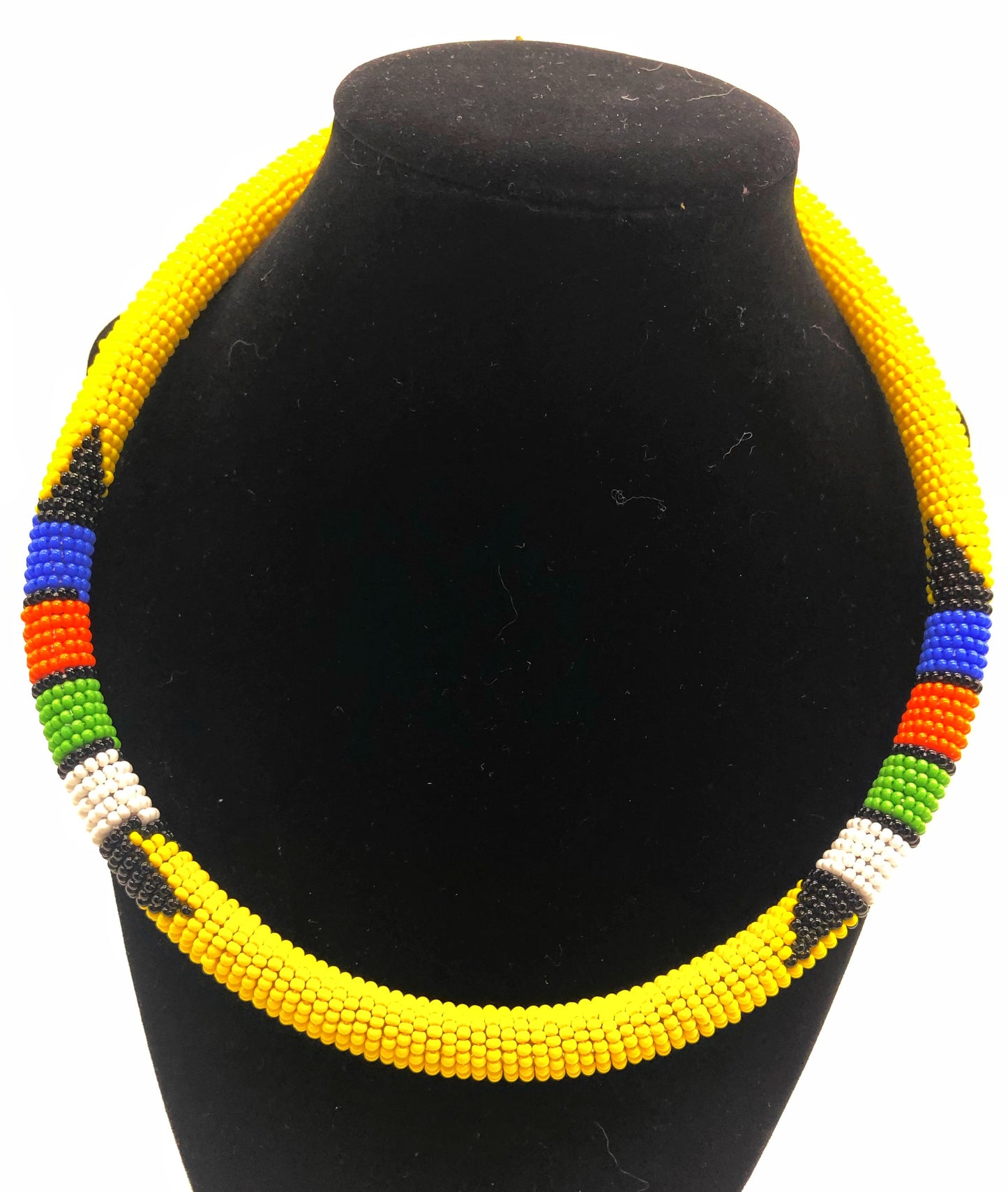Wear the epitome of Kenya style with The Bintiah necklace. This necklace is handmade using colorful seed beads that are intricately and tightly wrapped around a solid piece fo make a stunning statement with any outfit. Yellow with colorful bead accent