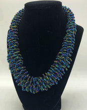 Load image into Gallery viewer, Stand out in style with this beautiful handmade loop bead style necklace.  Hover over the photo to see the detail of how the beads are made into a loop design.  Thoughtfully designed for style and stand out fashion. Approximately 18&quot; end to end. slate blue multi