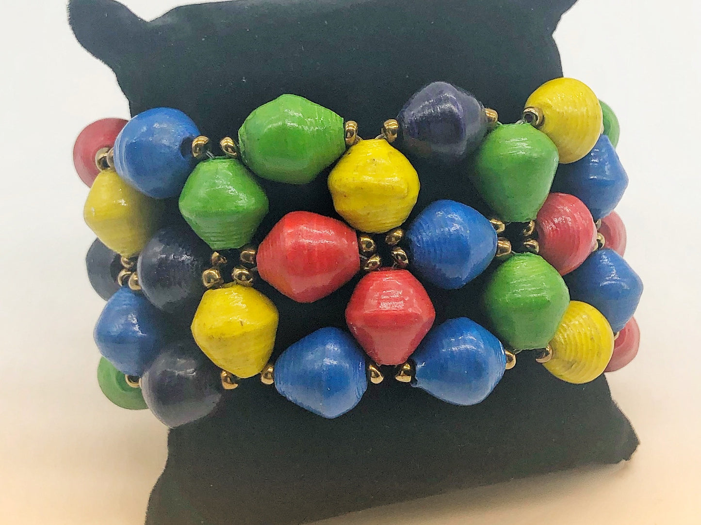 Handmade colorful bracelets made from magazines with accent seed beads in between. Each bead is hand rolled. Stylish and fashionable for casual or dressy. Fair trade. Stretch and memory wrap bracelets and single strand. The Patricia Collection is named after one of our ladies whose photo you will find within this collection.