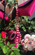 Load image into Gallery viewer, Handmade colorful long length pink necklaces and bracelets made from magazines with accent seed beads in between. Each bead is hand rolled. Stylish and fashionable for casual or dressy. Fair trade.  Pink medium bead necklace and purses.