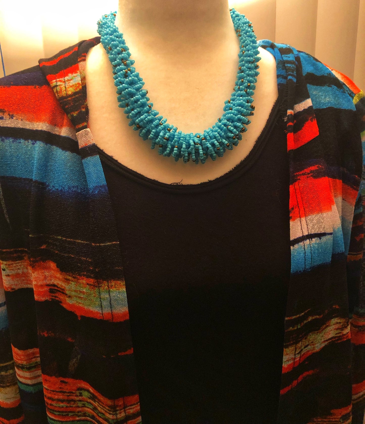Stand out in style with this beautiful handmade loop bead style necklace. Hover over the photo to see the detail of how the beads are made into a loop design. Thoughtfully designed for style and stand out fashion. Approximately 18" end to end.