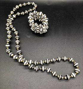 Hand crafted black and white medium length necklace and stretch bracelet set.  Approximately 18" Long. Made from magazines. Each bead individually rolled by hand.  Stylish and Fashionable for casual or dressy. Fair trade. 