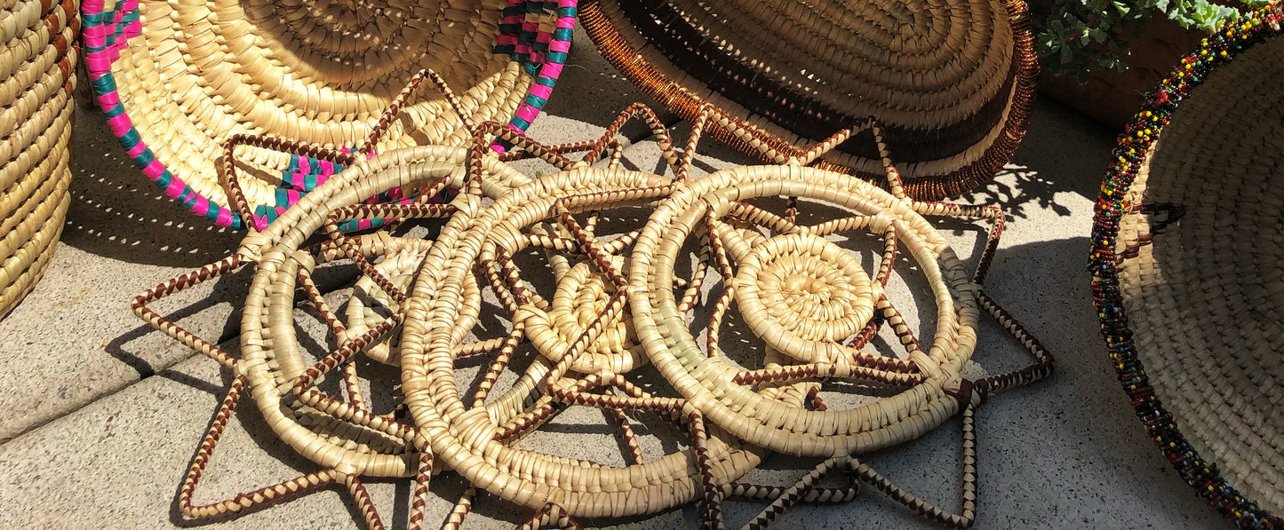 This sturdy hand made fair trade Turkana African trivet is handcrafted and woven from papyrus reed grown in Kenya. Use as a trivet for your table or as a beautiful home decoration. Natural color woven with brown into the design.