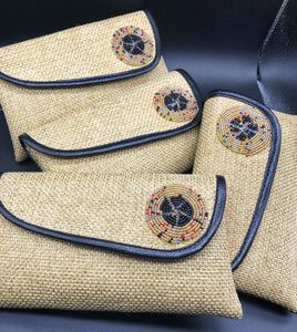 4 beige clutches leaning on one another in a row, round beads on flap, black piping lines flap edge