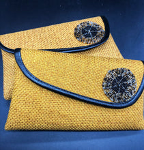 Load image into Gallery viewer, 2 gold clutches, round beads on flap, black piping around flap edge