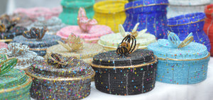 Fair Trade hand crafted basket made from seed beads. Round shape with lid. These baskets take 1 full day to create. Example photo of many baskets