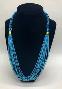 The Dinah necklace is named after one of our ladies whose photo you will find within this collection. The Dinah is a Fair trade hand crafted colorful seed bead necklace.  It is very delicate and classy.  Each necklace contains braided beads at top flowing into colorful hanging beads on the bottom. Each necklaces had solid color beads which are combined with colorful accent bead embellishment.     Slip over neck or easy open/close.