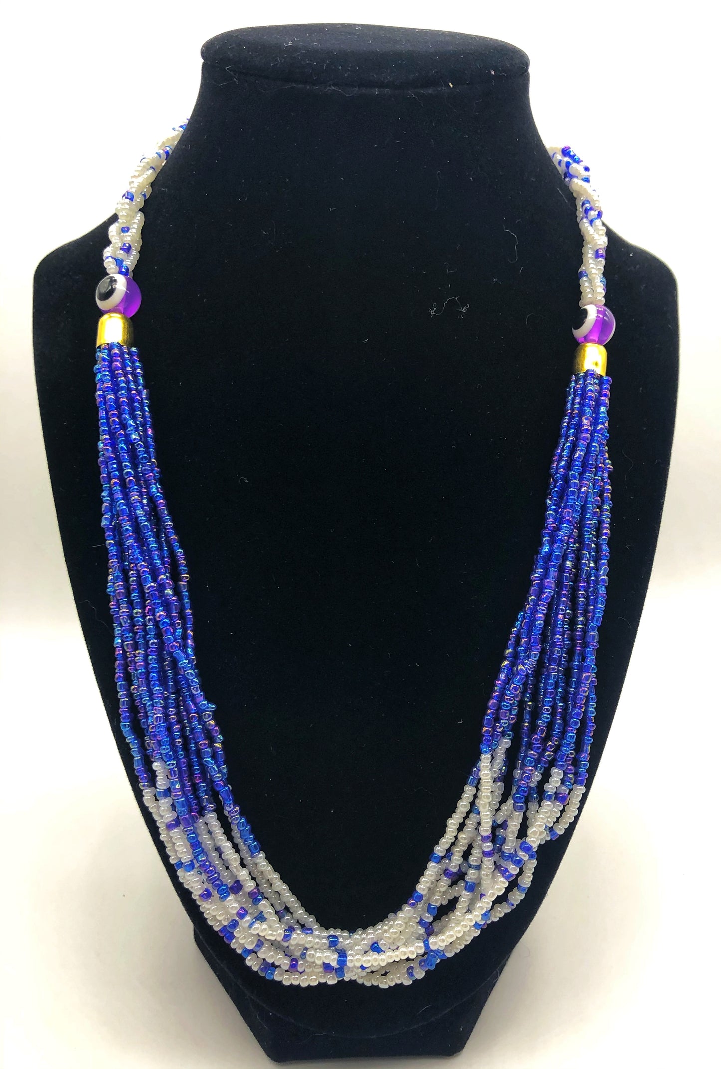 The Dinah necklace is named after one of our ladies whose photo you will find within this collection. The Dinah is a Fair trade hand crafted colorful seed bead necklace.  It is very delicate and classy.  Each necklace contains braided beads at top flowing into colorful hanging beads on the bottom. Each necklaces had solid color beads which are combined with colorful accent bead embellishment.     Slip over neck or easy open/close.