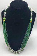 Load image into Gallery viewer, The Dinah necklace is named after one of our ladies whose photo you will find within this collection. The Dinah is a Fair trade hand crafted colorful seed bead necklace.  It is very delicate and classy.  Each necklace contains braided beads at top flowing into colorful hanging beads on the bottom. Each necklaces had solid color beads which are combined with colorful accent bead embellishment.     Slip over neck or easy open/close. Green and white
