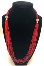 Load image into Gallery viewer, The Dinah necklace is named after one of our ladies whose photo you will find within this collection. The Dinah is a Fair trade hand crafted colorful seed bead necklace.  It is very delicate and classy.  Each necklace contains braided beads at top flowing into colorful hanging beads on the bottom. Each necklaces had solid color beads which are combined with colorful accent bead embellishment.     Slip over neck or easy open/close. red with black accent