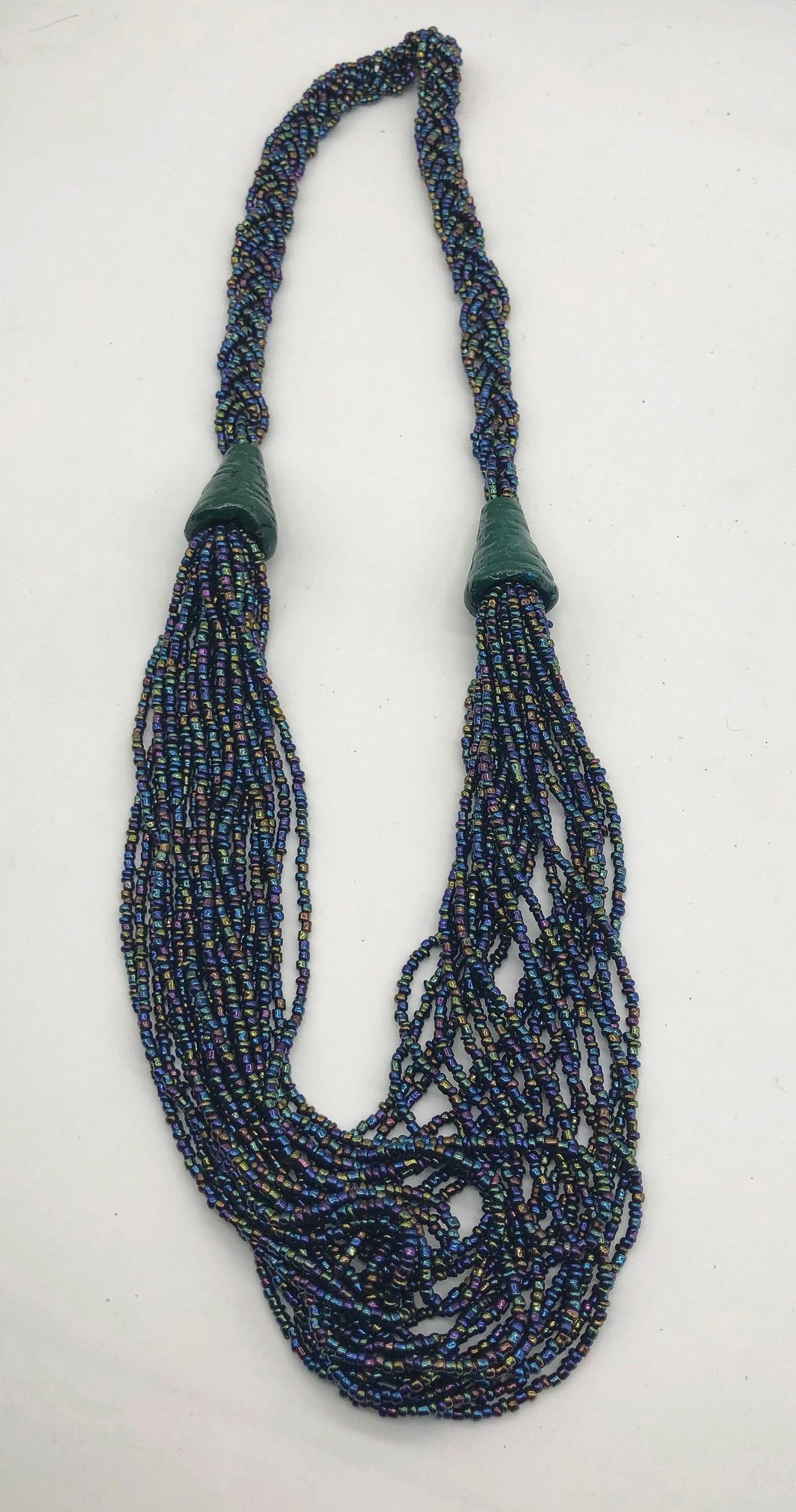 Make a statement with this beautiful handmade seed bead necklace.  Styled with braided beads around the neck flowing into a loose styled design. Slate with multi color bead accent