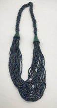 Load image into Gallery viewer, Make a statement with this beautiful handmade seed bead necklace.  Styled with braided beads around the neck flowing into a loose styled design. Slate with multi color bead accent