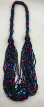 Load image into Gallery viewer, Make a statement with this beautiful handmade seed bead necklace.  Styled with braided beads around the neck flowing into a loose styled design. Black with pink and blue bead accent