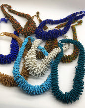Load image into Gallery viewer, Stand out in style with this beautiful handmade loop bead style necklace.  Hover over the photo to see the detail of how the beads are made into a loop design.  Thoughtfully designed for style and stand out fashion. Approximately 18&quot; end to end.  Multiple colors shown.