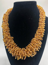 Load image into Gallery viewer, Stand out in style with this beautiful handmade loop bead style necklace.  Hover over the photo to see the detail of how the beads are made into a loop design.  Thoughtfully designed for style and stand out fashion. Approximately 18&quot; end to end.  light gold