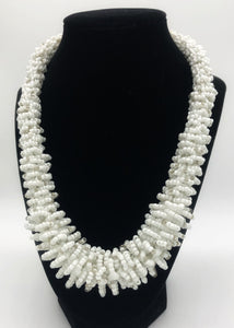 Stand out in style with this beautiful handmade loop bead style necklace.  Hover over the photo to see the detail of how the beads are made into a loop design.  Thoughtfully designed for style and stand out fashion. Approximately 18" end to end.  White with silver bead accent