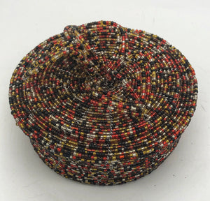 Fair Trade hand crafted basket made from seed beads. Round shape with lid. These baskets take 1 full day to create. Gold and black multi