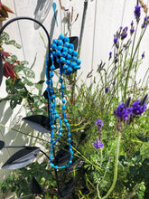 Load image into Gallery viewer, Long handmade paper bead necklace and stretch or memory wrap bracelet set blue color. Necklace is approximately 30” long and usually worn doubled. Bracelet is a wrap bracelet. Handcrafted from magazines. Fair trade. Weathered blue necklace and stretch bracelet pictured