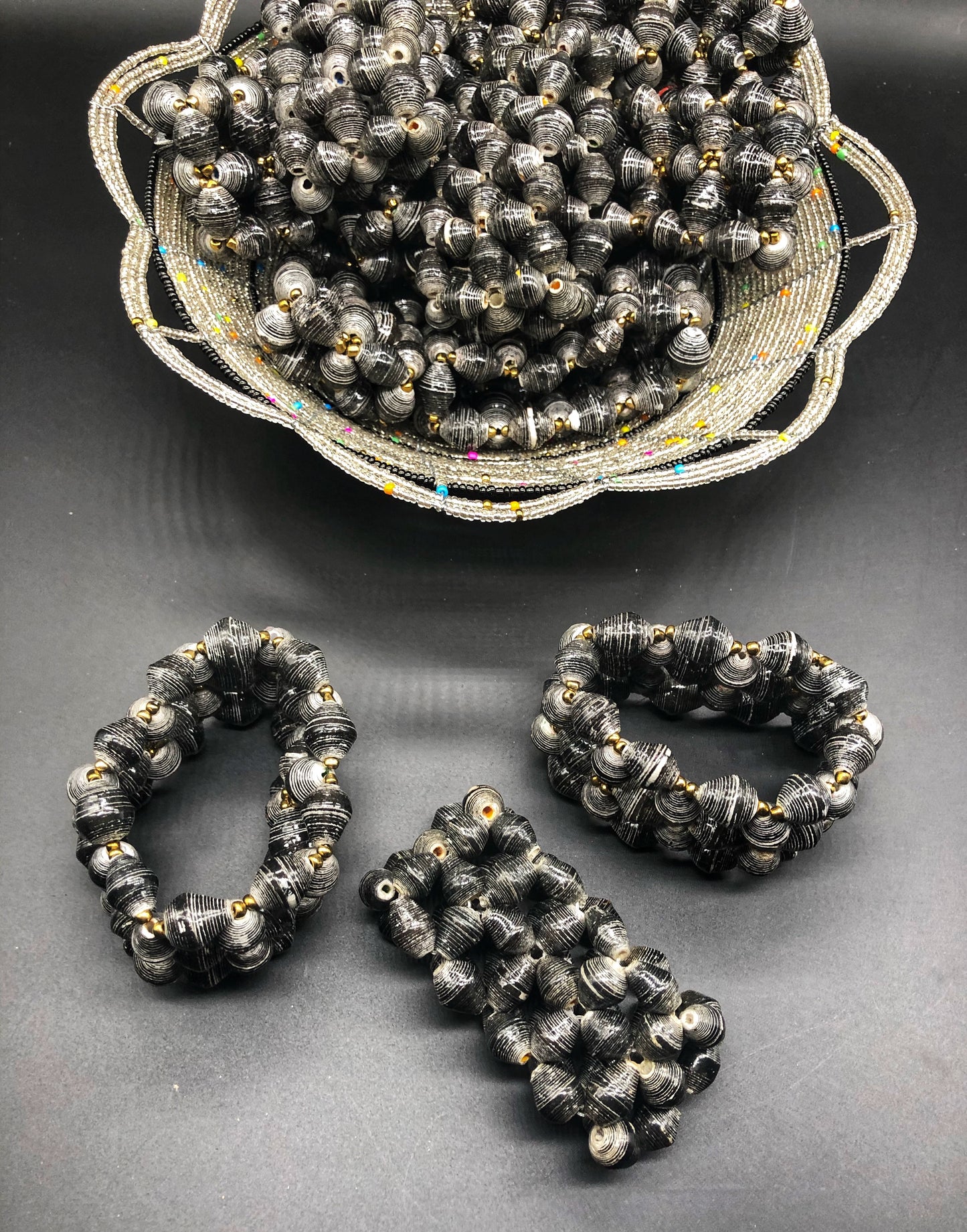 Hand crafted faded/weathered black paper bead stretch bracelet made from magazines and each bead individually rolled by hand.  Stylish and Fashionable for casual or dressy. Fair trade.