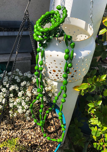 Long handmade paper bead necklace and memory wrap bracelet set green color. Necklace is approximately 30” long and usually worn doubled. Bracelet is a wrap bracelet. Handcrafted from magazines. Fair trade.   Color: Green memory wrap bracelet and necklace pictured.
