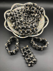 Hand crafted faded/weathered black paper bead stretch bracelet made from magazines and each bead individually rolled by hand.  Stylish and Fashionable for casual or dressy. Fair trade.