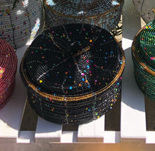 Load image into Gallery viewer, Fair Trade hand crafted basket made from seed beads. Round shape with lid. These baskets take 1 full day to create.  Black with multi color bead accent and gold bead around edge of lid. 