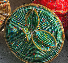 Load image into Gallery viewer, Fair Trade hand crafted basket made from seed beads. Round shape with lid. These baskets take 1 full day to create.  Sea foam green with gold accent around the edge of lid. 