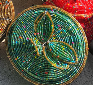 Fair Trade hand crafted basket made from seed beads. Round shape with lid. These baskets take 1 full day to create.  Sea foam green with gold accent around the edge of lid. 