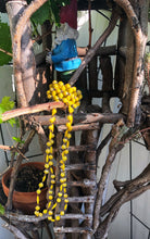 Load image into Gallery viewer, Long handmade paper bead necklace and stretch bracelet set weathered yellow color. Necklace is approximately 30” long and usually worn doubled. Bracelet is a stretch bracelet. Handcrafted from magazines. Fair trade.   Color Yellow stretch bracelet and necklace pictured
