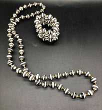 Load image into Gallery viewer, Hand crafted black and white medium length necklace and stretch bracelet set.  Approximately 18&quot; Long. Made from magazines. Each bead individually rolled by hand.  Stylish and Fashionable for casual or dressy. Fair trade. 