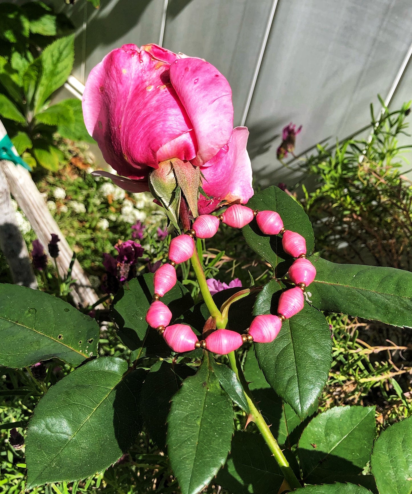 Handmade colorful long length pink necklaces and bracelets made from magazines with accent seed beads in between. Each bead is hand rolled. Stylish and fashionable for casual or dressy. Fair trade.  Pink Single Strand bracelet.