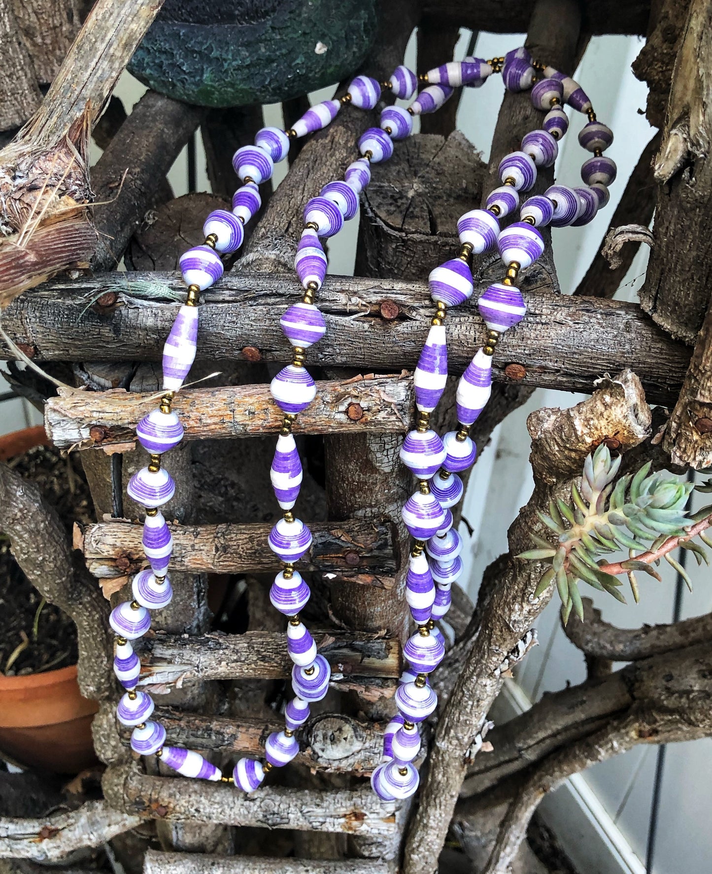 Handmade long length multicolor necklace made from magazines with accent seed beads in between. Each bead is hand rolled. purple and white pictured.