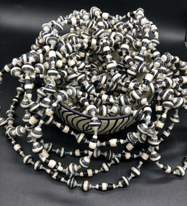 Hand crafted black and white paper bead necklace approximately 30” long with clear bead embellishment. Usually worn doubled. Each bead individually rolled by hand from magazines.  Stylish and Fashionable for casual or dressy. Fair trade.  